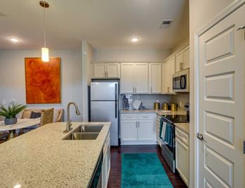 White cabinetry and appliances in kitchen